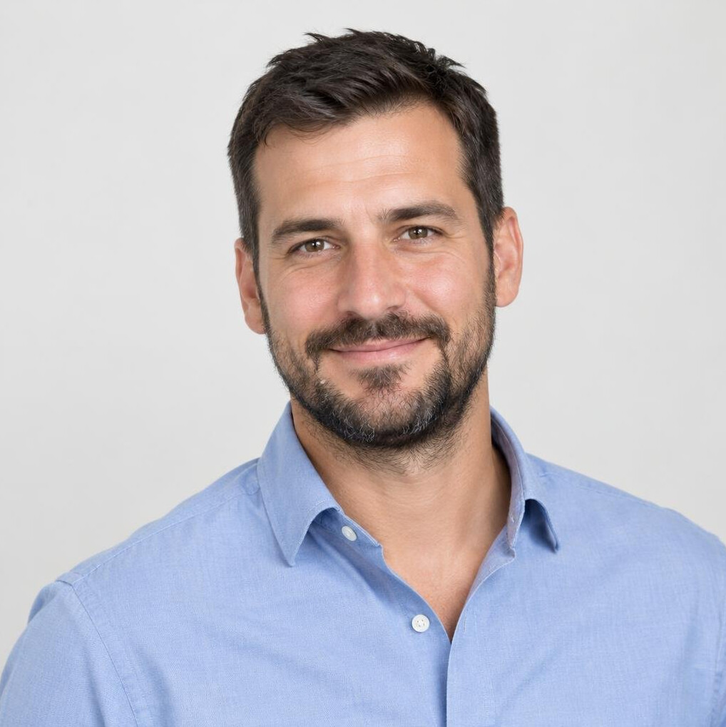 Portrait of a smiling man with a short beard in a casual shirt